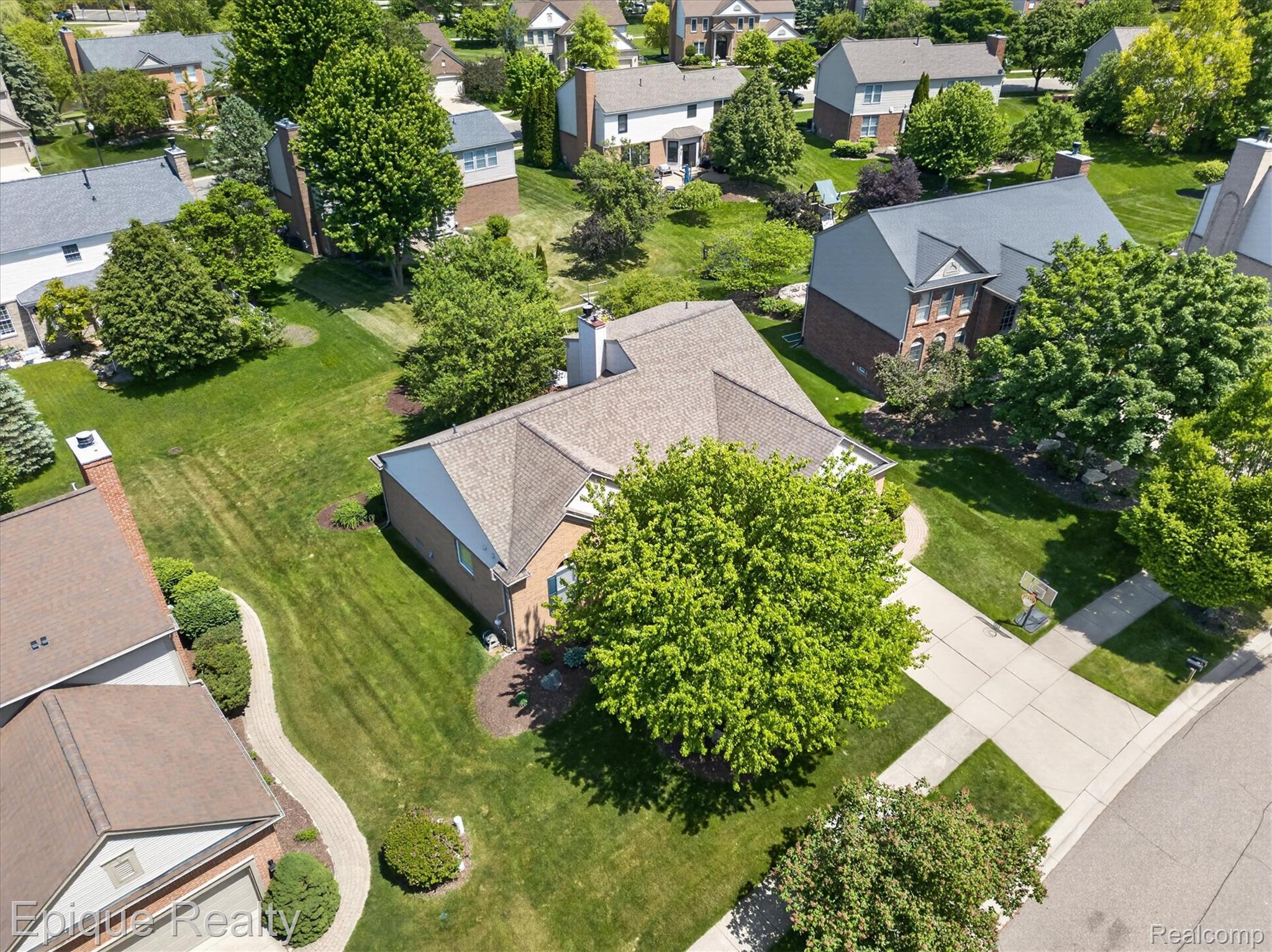 760 Caribou Court Rochester, MI 48307 - Photo 52 of 67 Aerial perspective showcasing a residential property with a shingle roof and brick exterior accents