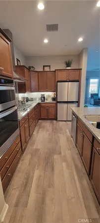 a kitchen with stainless steel appliances granite countertop a sink and cabinets
