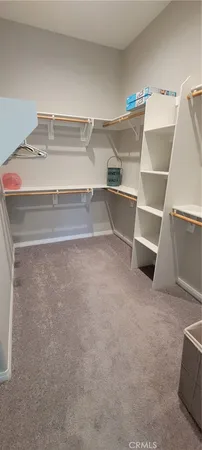 a view of an empty room with racks on the wall