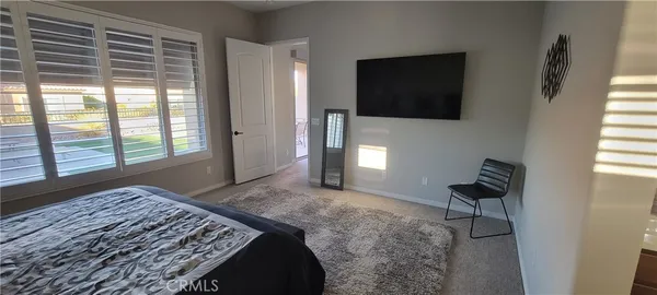 a bedroom with a bed and a television