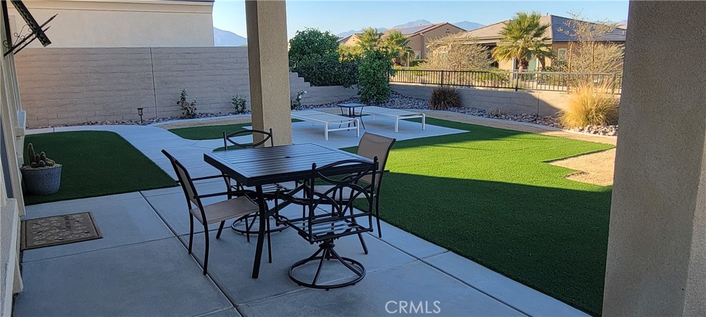 82 Burgundy Rancho Mirage, CA 92270 - Photo 26 of 42 a backyard of a house with table and chairs