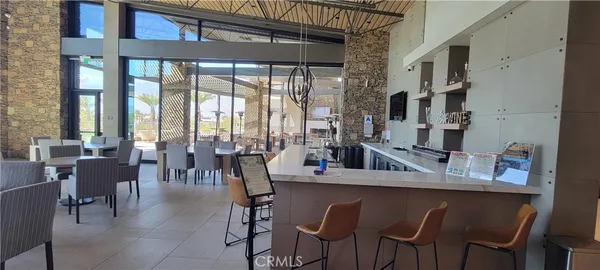 a dining room with stainless steel appliances granite countertop a table and chairs