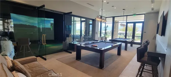 a living room with furniture a table and a large window