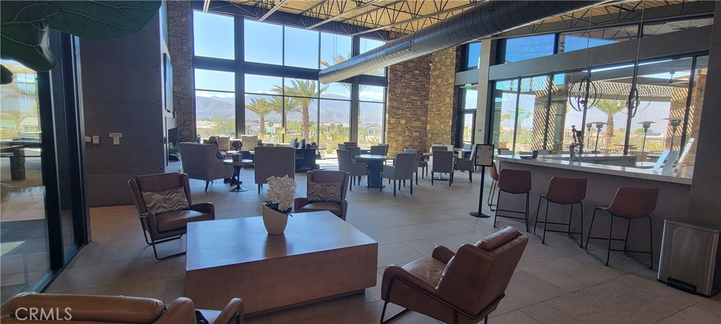 82 Burgundy Rancho Mirage, CA 92270 - Photo 39 of 42 a living room with furniture large windows and wooden floor