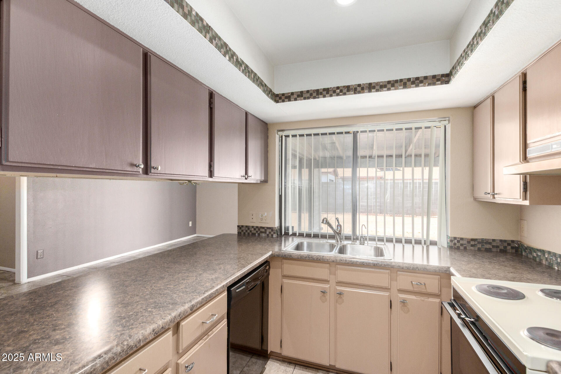 4740 West Bloomfield Road Glendale, AZ 85304 - Photo 14 of 34 a kitchen with granite countertop a sink and a white wooden cabinets