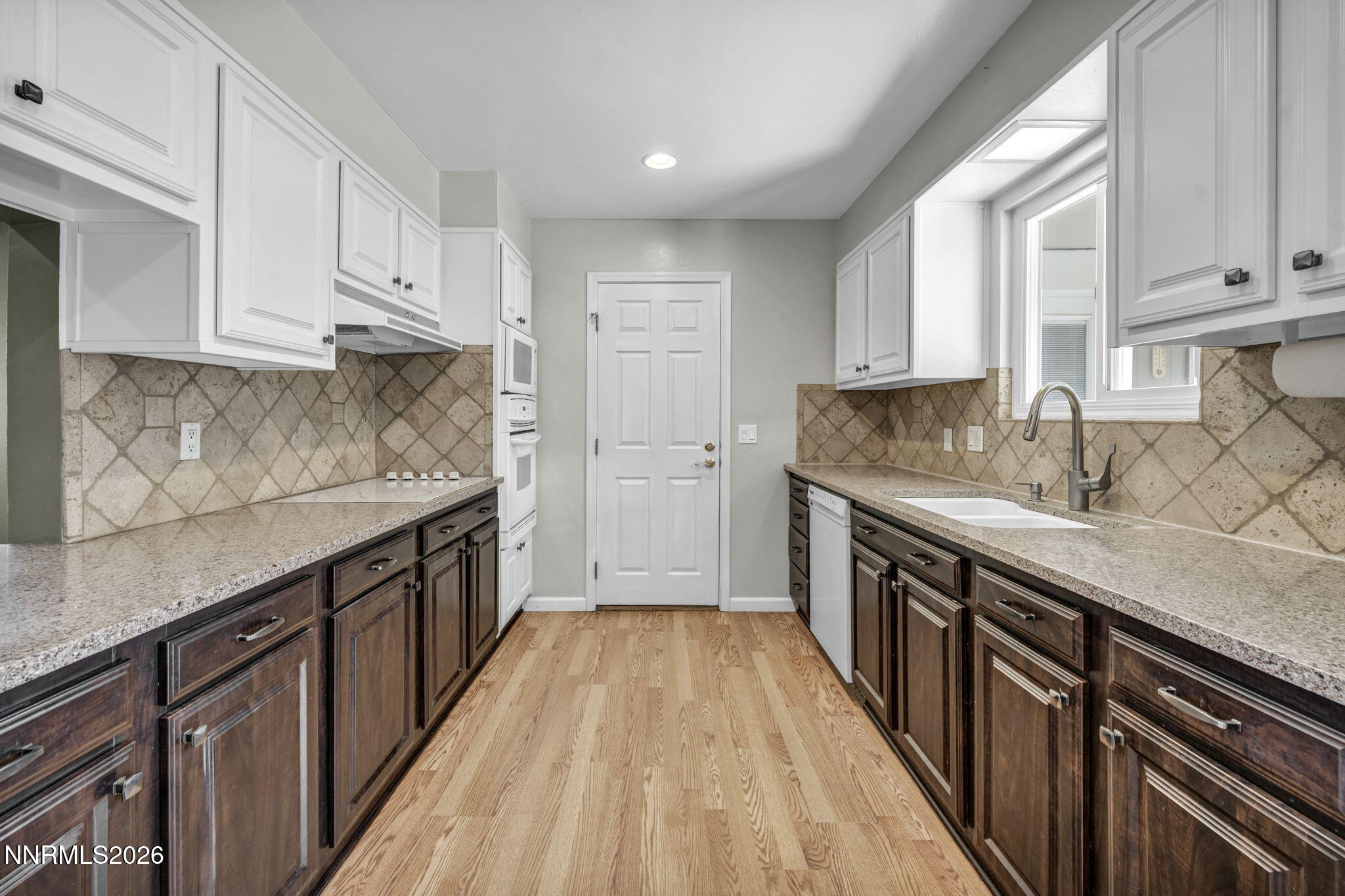 14190 Rim Rock Drive Reno, NV 89521 - Photo 20 of 68 a kitchen with granite countertop a sink dishwasher stove and cabinets with wooden floor