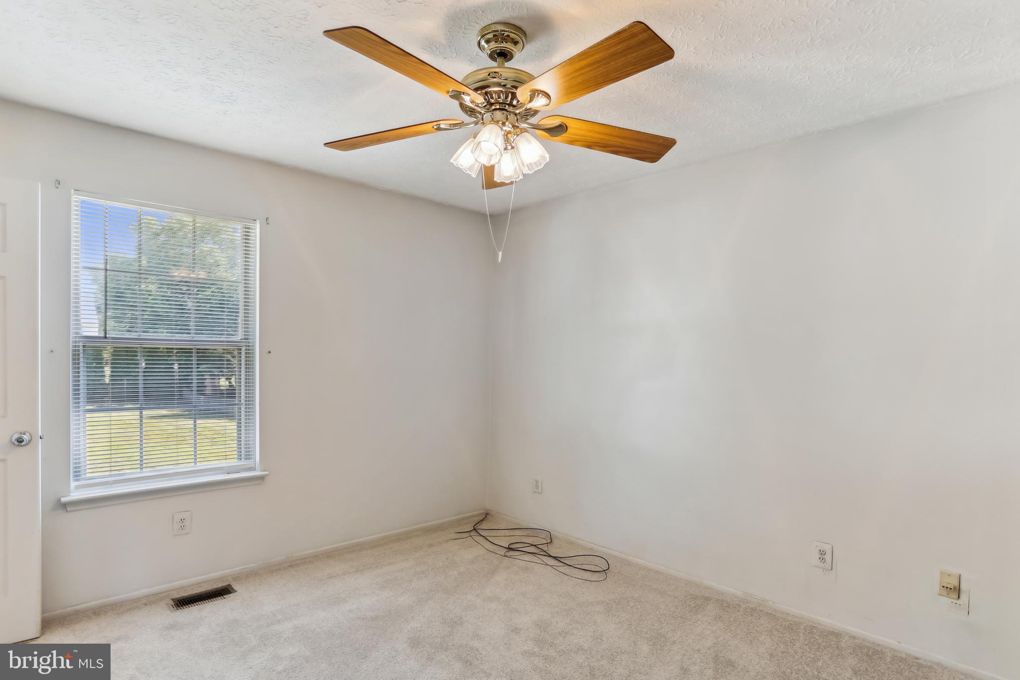 8225 Grainfield Road Severn, MD 21144 - Photo 15 of 35 an empty room with window and ceiling fan