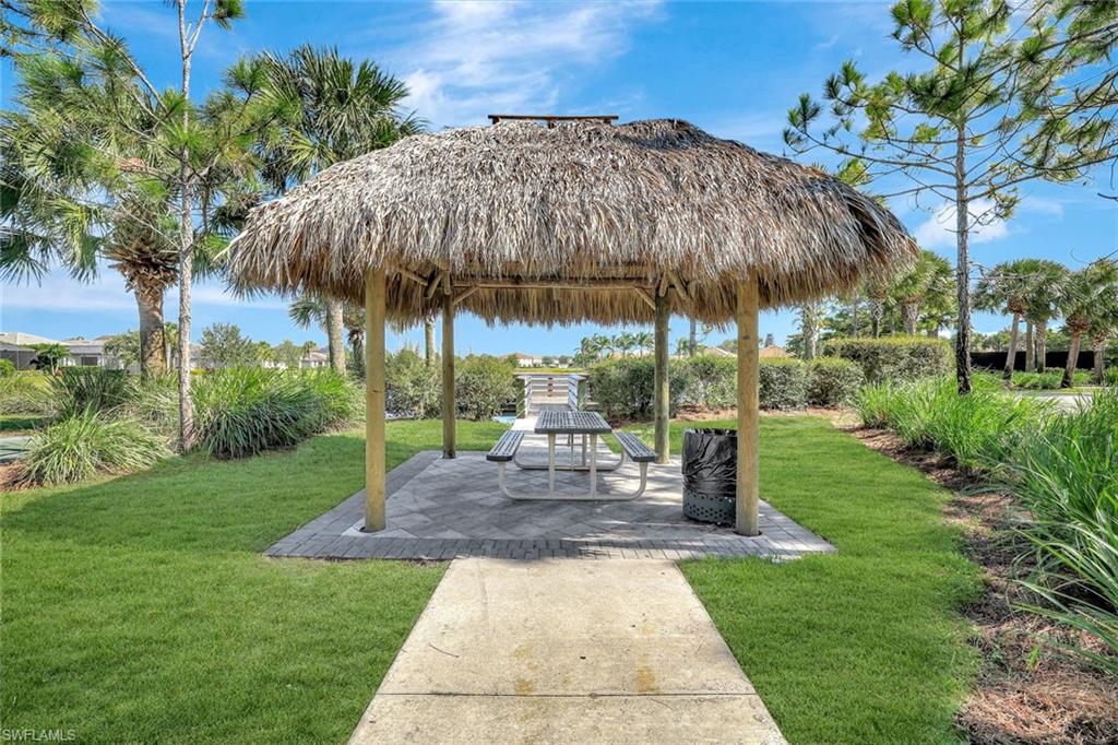 1750 Alameda Drive Naples, FL 34120 - Photo 23 of 39 a view of a garden with a bench in patio