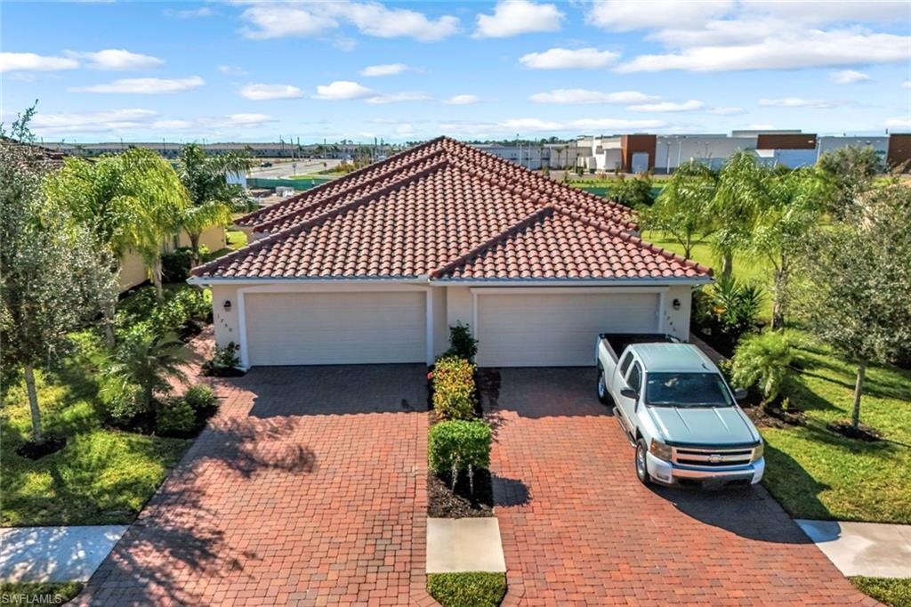 1750 Alameda Drive Naples, FL 34120 - Photo 3 of 39 a front view of a house with garden
