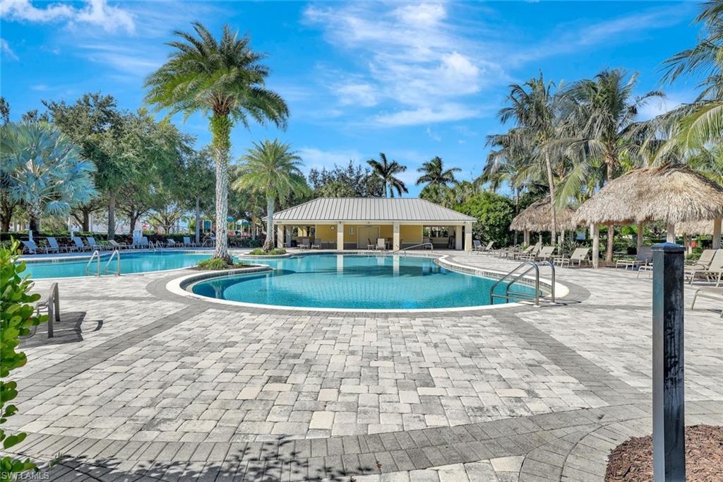 1750 Alameda Drive Naples, FL 34120 - Photo 31 of 39 a view of a swimming pool with a garden
