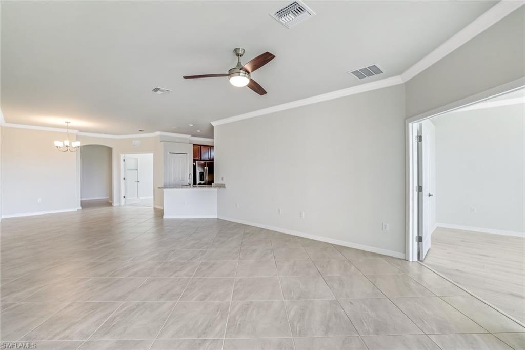 1750 Alameda Drive Naples, FL 34120 - Photo 5 of 39 a view of a kitchen with a dishwasher and white cabinets with wooden floor