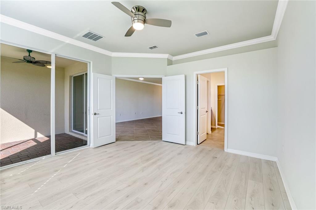 1750 Alameda Drive Naples, FL 34120 - Photo 8 of 39 a view of empty room with wooden floor and fan