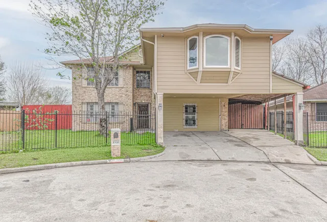 a front view of a house with a garden and garage