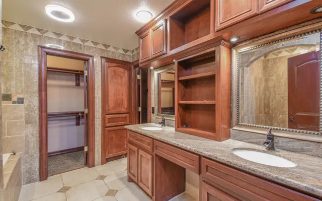 a view of an empty room with window and cabinet