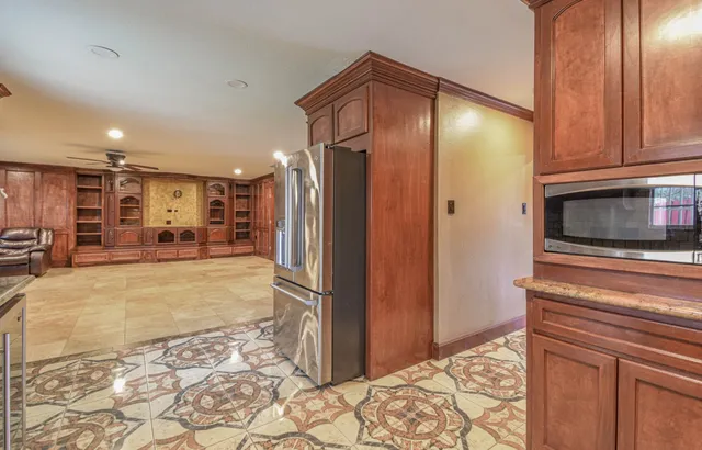a view of a kitchen with a refrigerator and a stove