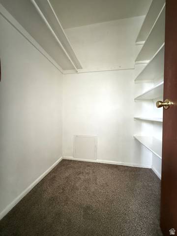 460 200 South Provo, UT 84606 - Photo 56 of 66 Interior space featuring wall-mounted shelving, white walls, and a brown carpeted floor