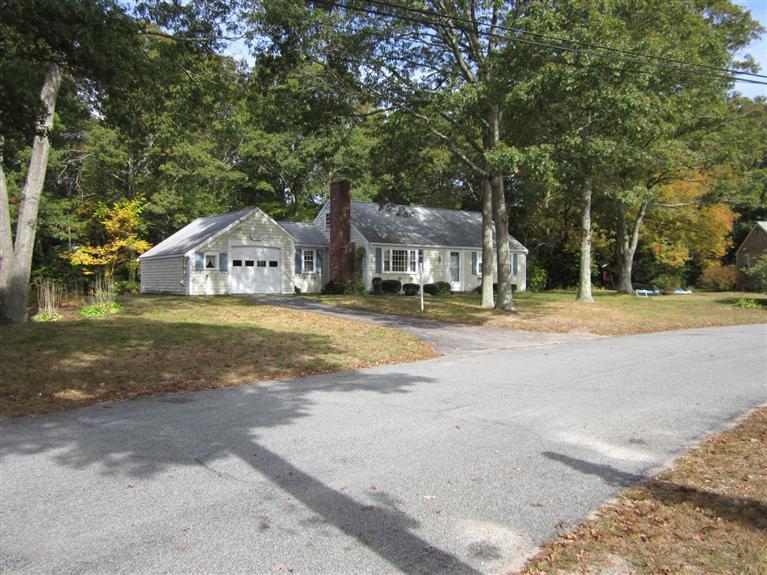 18 Birchill Road Centerville, MA 02632 - Photo 1 of 18 a front view of a house with a yard and trees