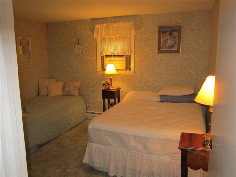 18 Birchill Road Centerville, MA 02632 - Photo 14 of 18 a bedroom with a bed and a lamp