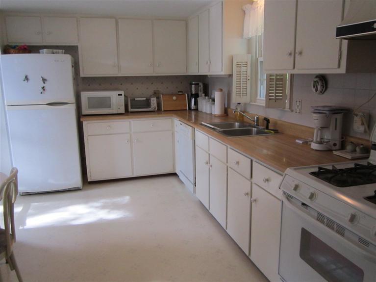 18 Birchill Road Centerville, MA 02632 - Photo 8 of 18 a kitchen with granite countertop white cabinets and white appliances