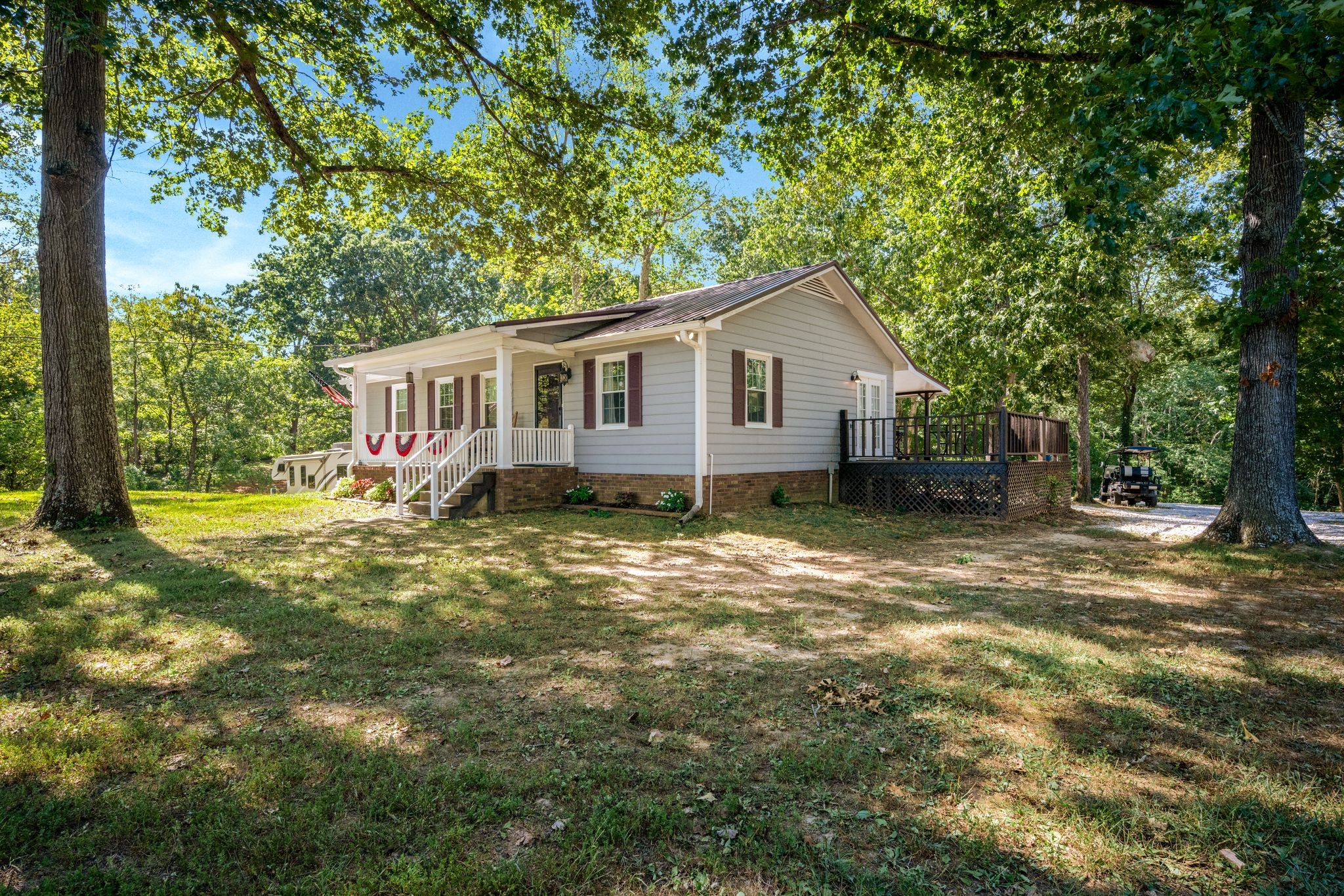 5835 Dog Creek Road Primm Springs, TN 38476 - Photo 37 of 37 a view of a house with a backyard and a tree