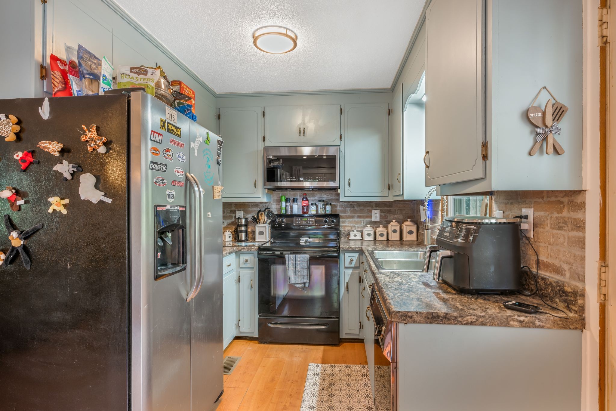 5835 Dog Creek Road Primm Springs, TN 38476 - Photo 8 of 37 a kitchen with stainless steel appliances granite countertop a refrigerator and a stove top oven