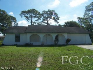 106 Delaware Road Lehigh Acres, FL 33936 - Photo 1 of 8 a view of a backyard