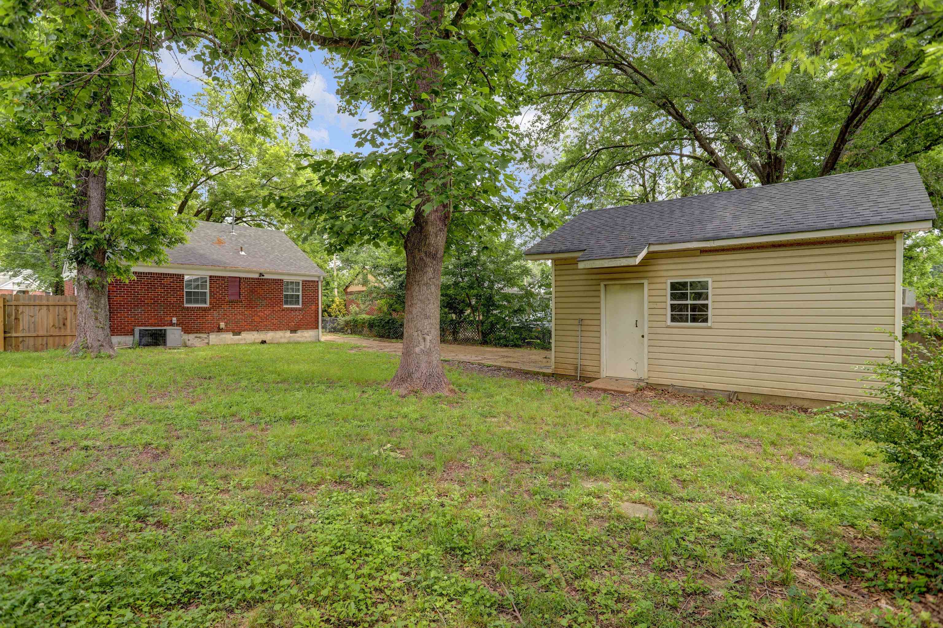 3855 South Brighton Road Memphis, TN 38128 - Photo 20 of 21 a front view of a house with yard and tree