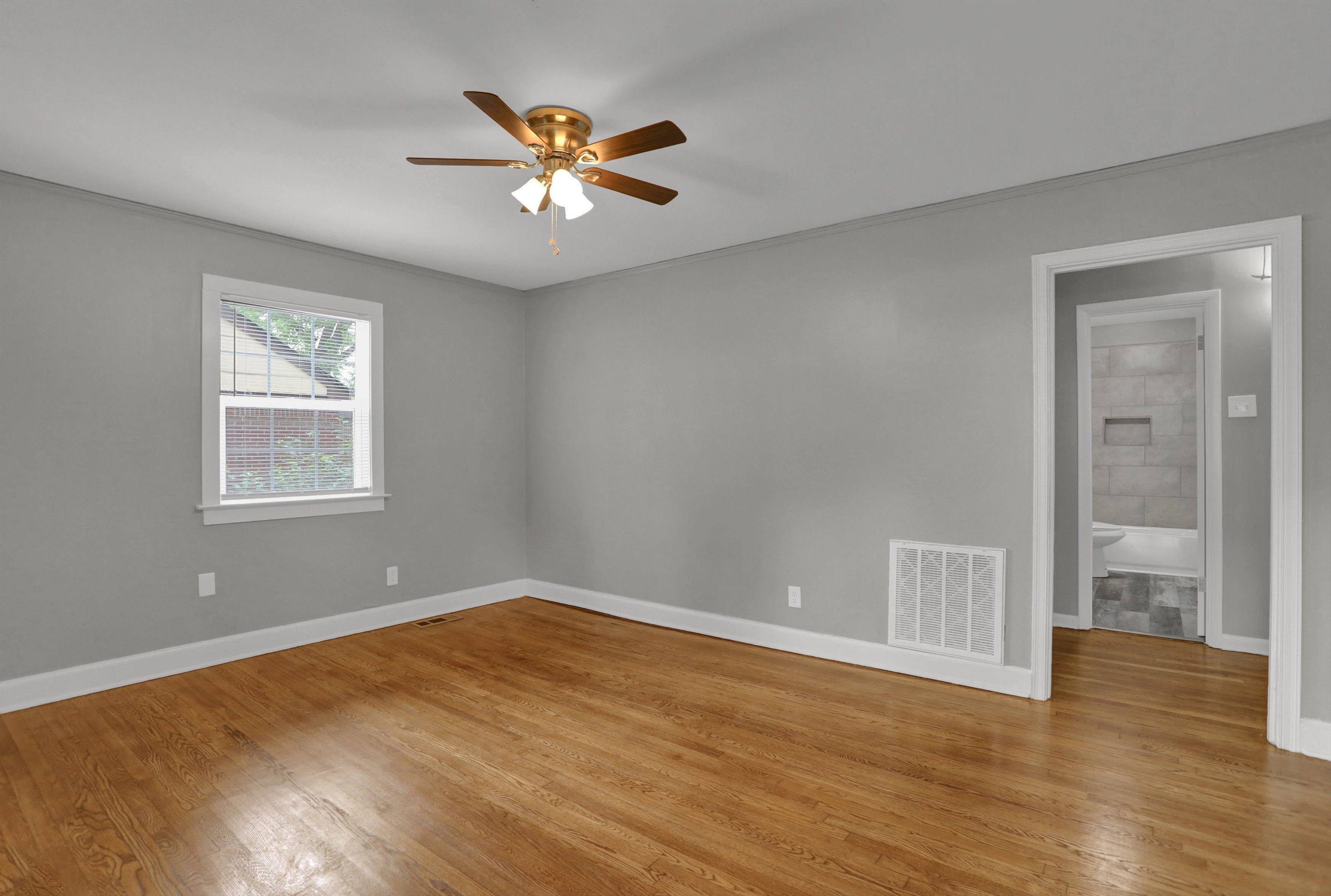 3855 South Brighton Road Memphis, TN 38128 - Photo 4 of 21 a view of an empty room with wooden floor and a window