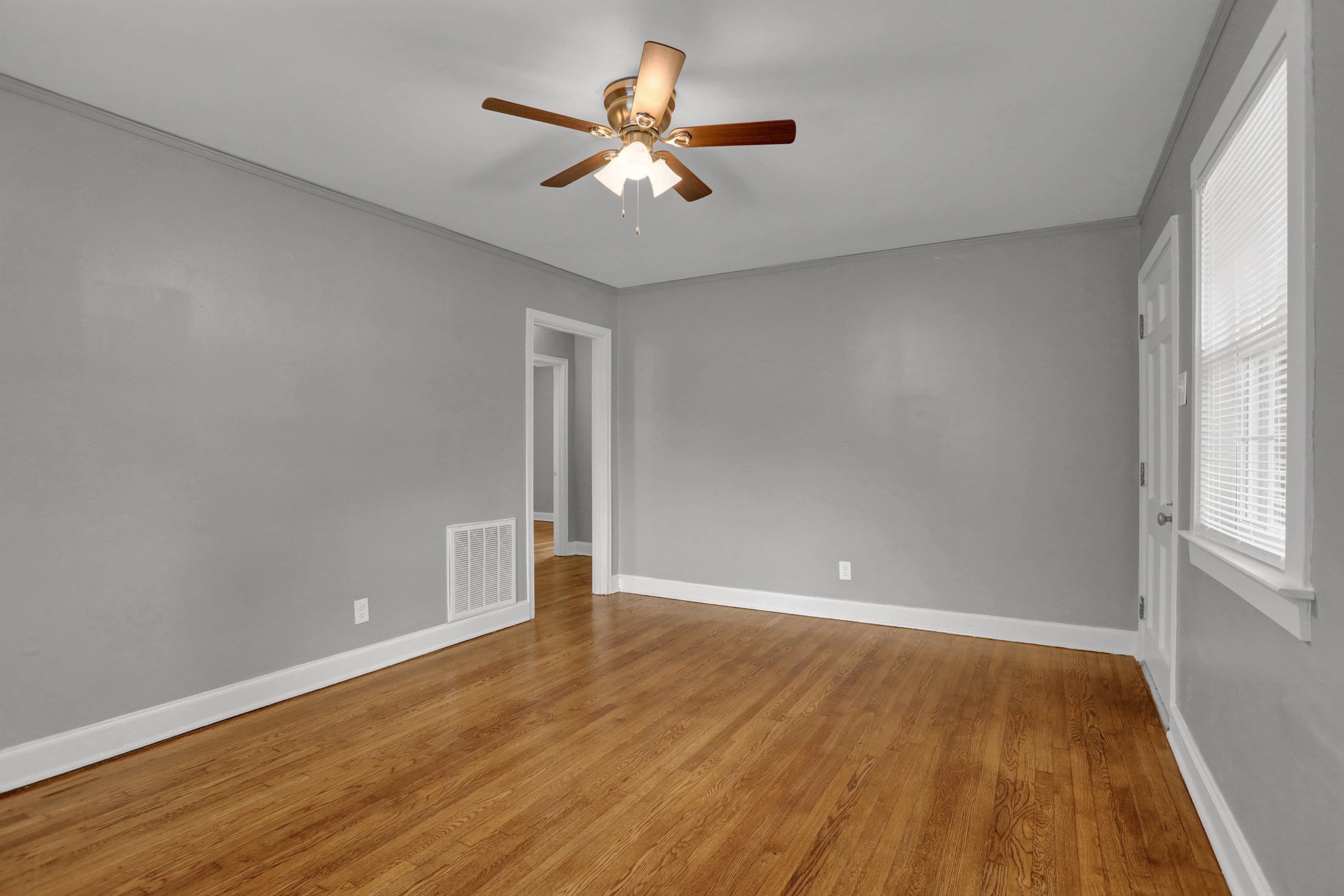 3855 South Brighton Road Memphis, TN 38128 - Photo 5 of 21 an empty room with wooden floor and windows