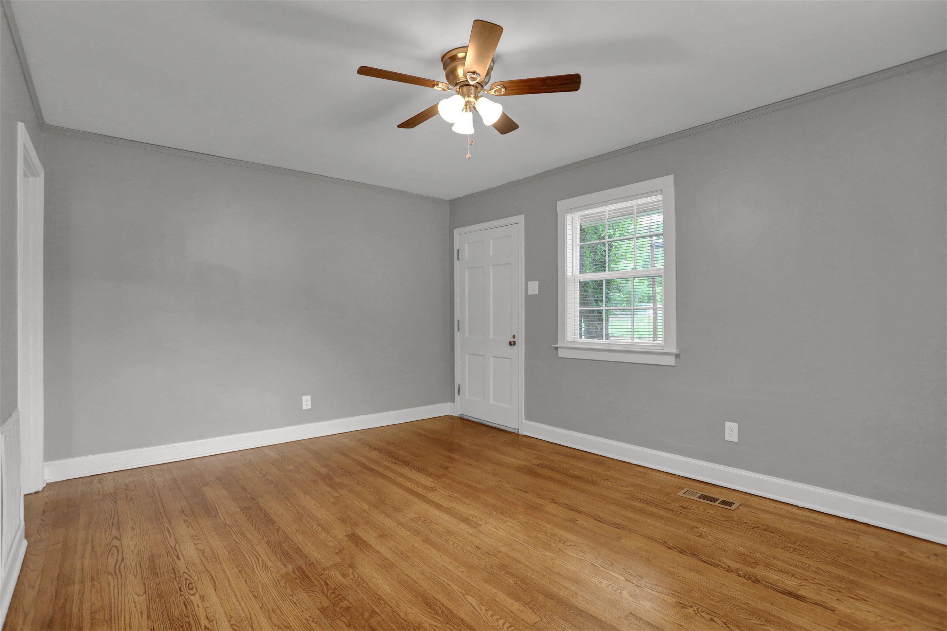 3855 South Brighton Road Memphis, TN 38128 - Photo 6 of 21 wooden floor in an empty room with a window