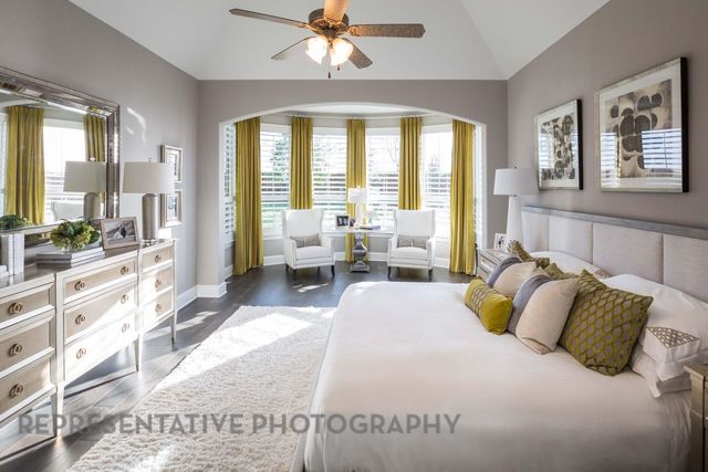 a spacious bedroom with a large bed and a large window