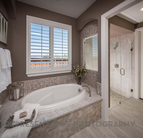 a spacious bathroom with bathtub and shower