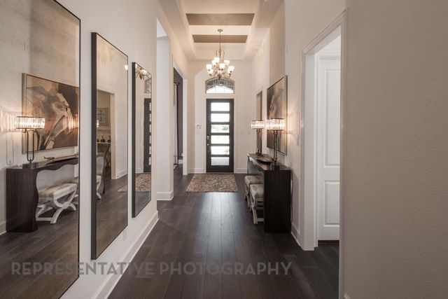 a view of hallway with livingroom and wooden floor