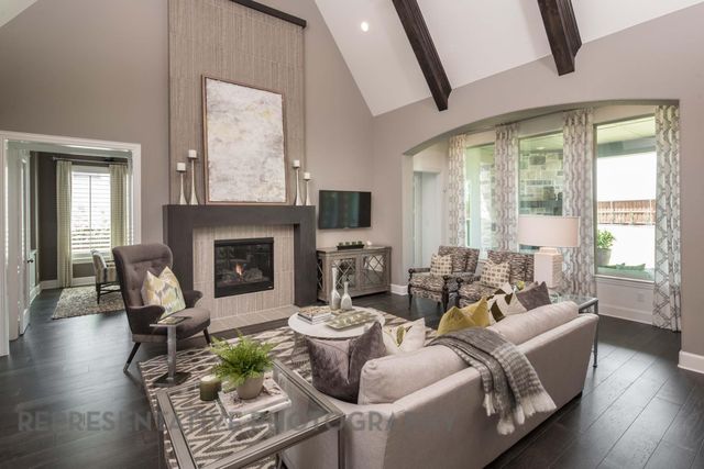 a living room with furniture large window and wooden floor