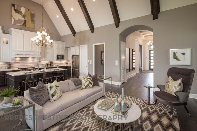 a living room with furniture and a chandelier