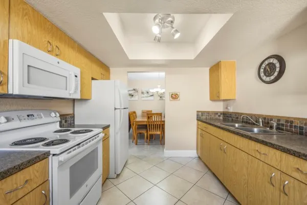 a kitchen with stainless steel appliances granite countertop a stove and a sink