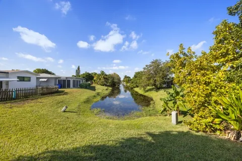 a swimming pool with outdoor seating and yard