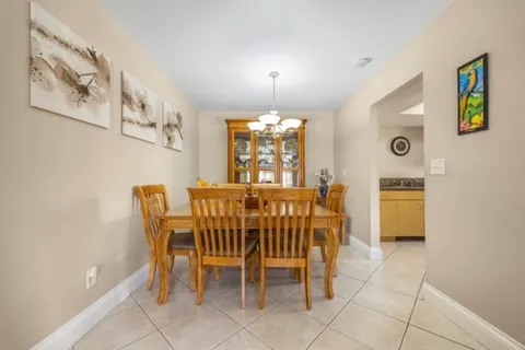 a view of a dining room with furniture and a chandelier