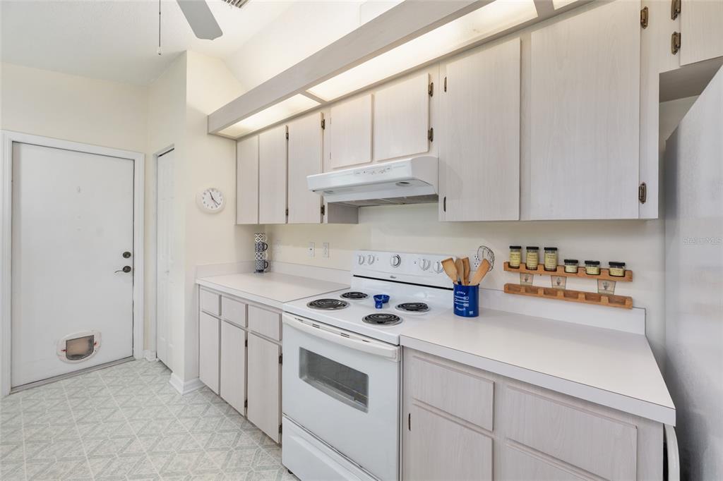 8038 Southwest 108th Loop Ocala, FL 34481 - Photo 13 of 48 a kitchen with stainless steel appliances white cabinets and a stove