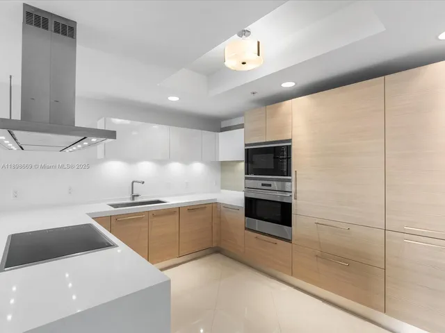 a kitchen with sink and refrigerator