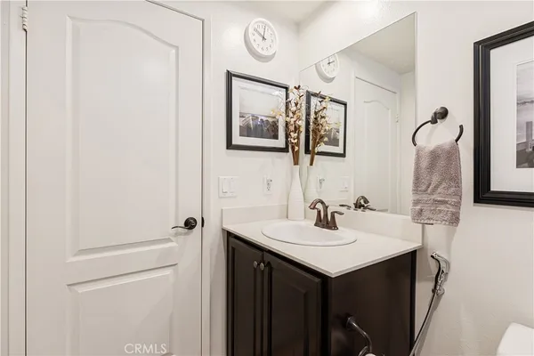 a bathroom with a sink vanity and a mirror