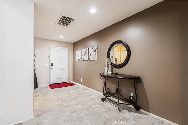 a view of a room with a hanging light and kitchen