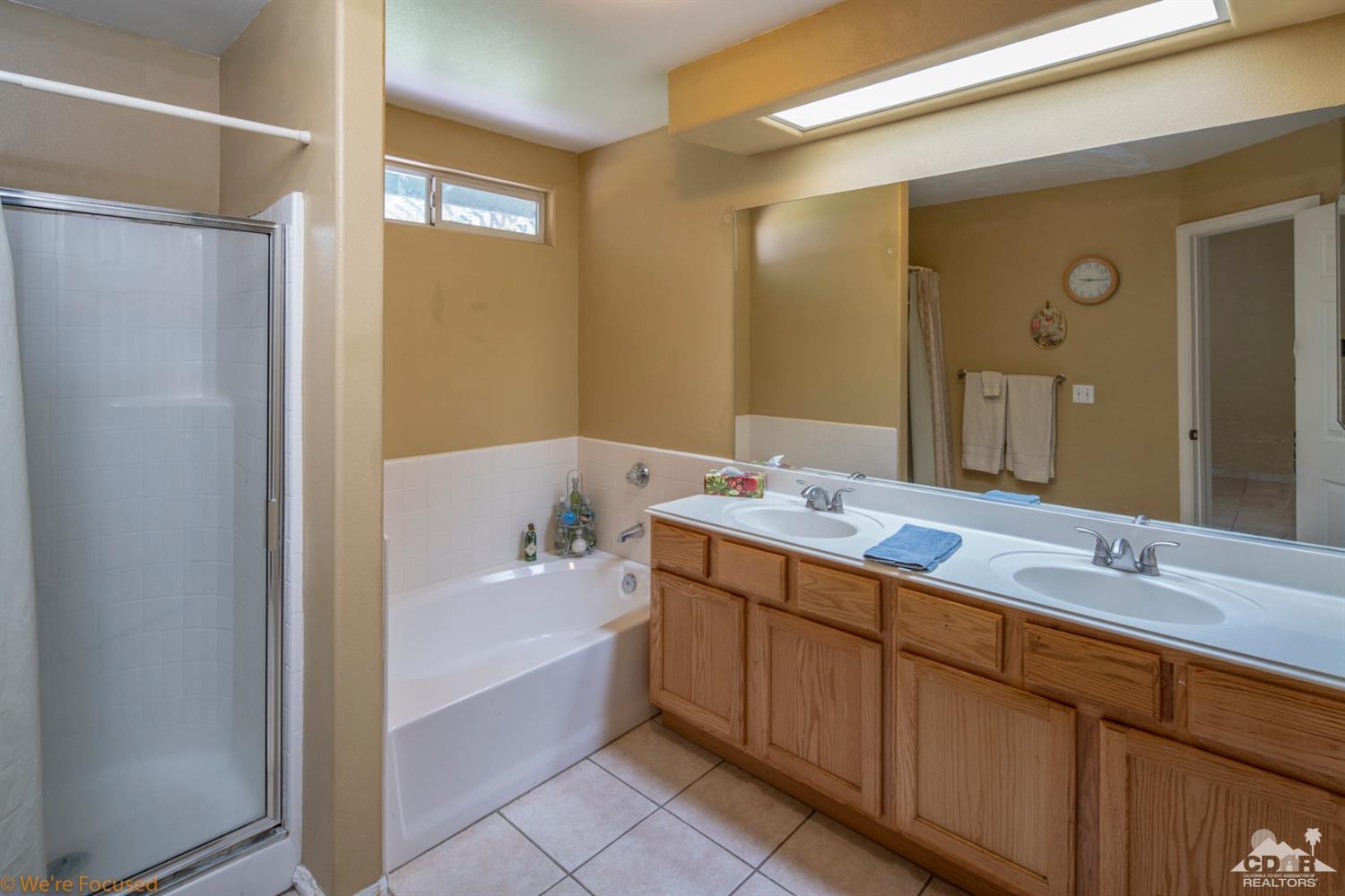 67235 Ovante Road Cathedral City, CA 92234 - Photo 11 of 16 a bathroom with a tub sink and mirror