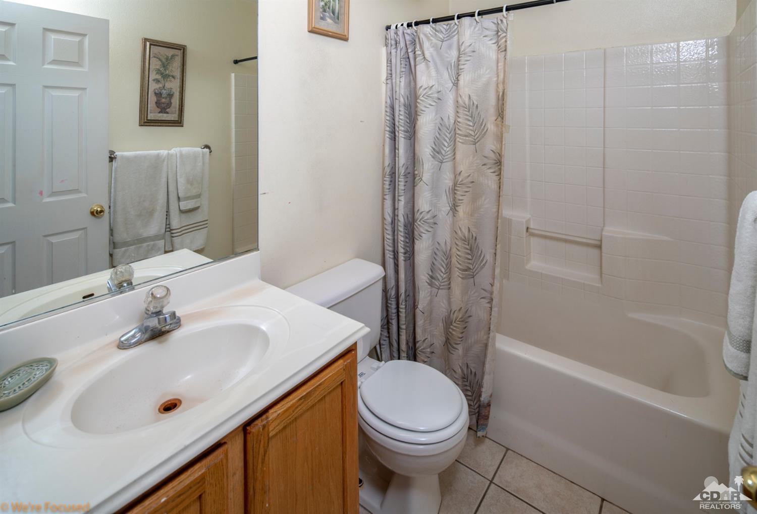 67235 Ovante Road Cathedral City, CA 92234 - Photo 14 of 16 a bathroom with a sink a toilet and shower