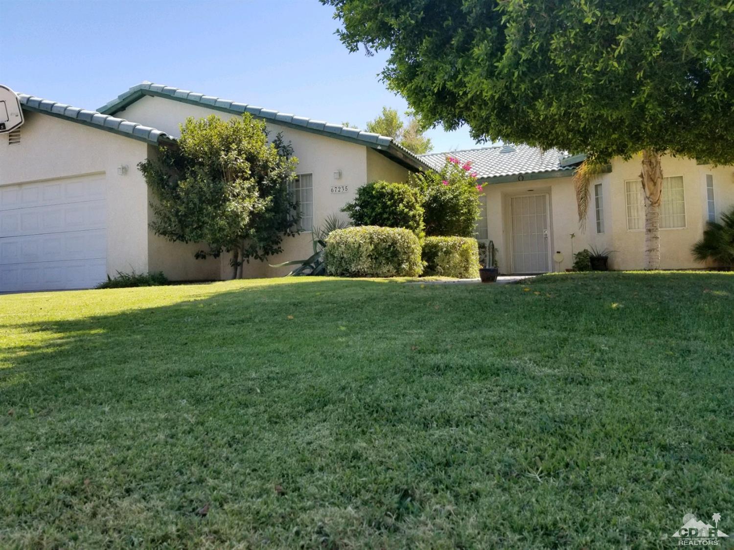 67235 Ovante Road Cathedral City, CA 92234 - Photo 16 of 16 a view of a house with a big yard and large tree
