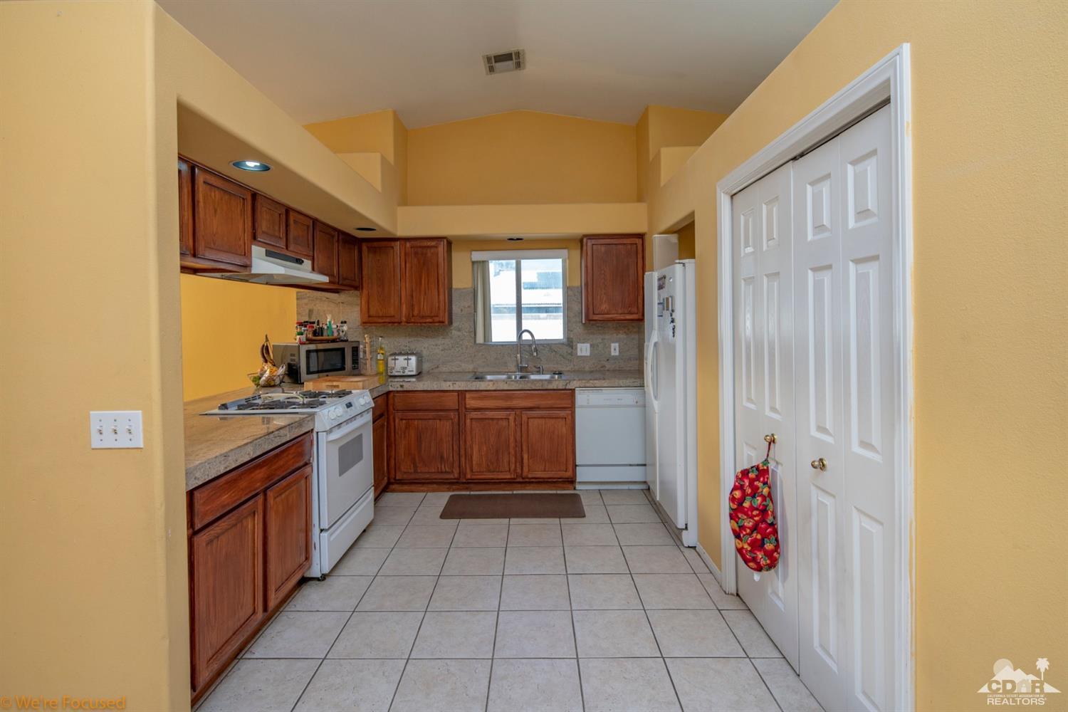 67235 Ovante Road Cathedral City, CA 92234 - Photo 8 of 16 a kitchen with a sink counter top space and stainless steel appliances