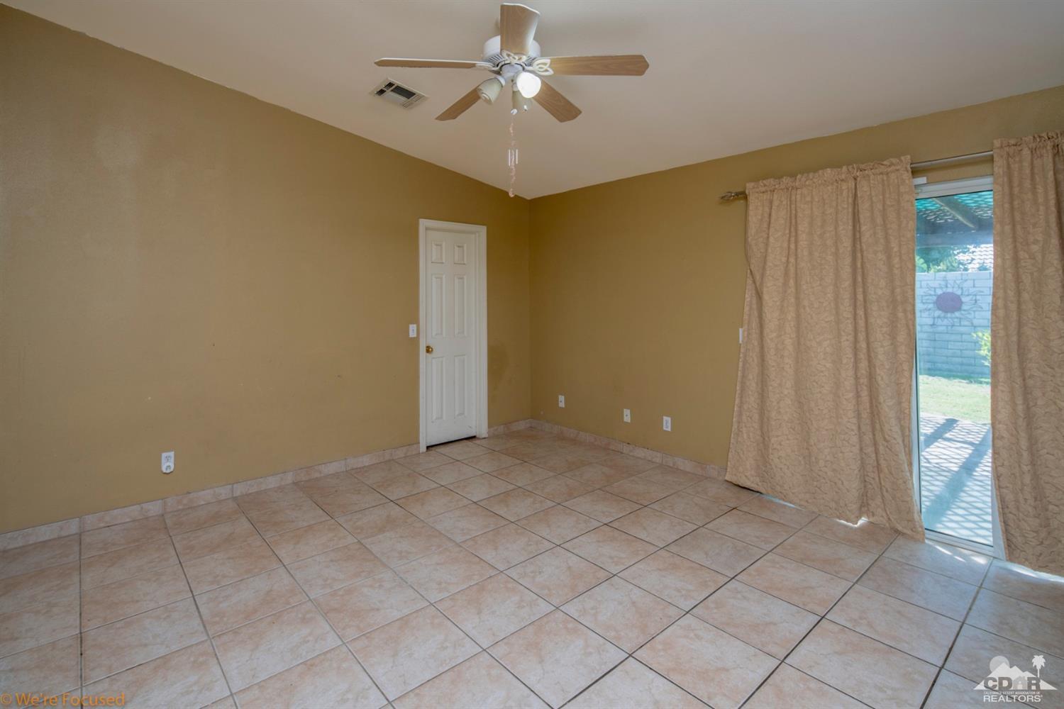 67235 Ovante Road Cathedral City, CA 92234 - Photo 10 of 16 wooden floor in an empty room with a window