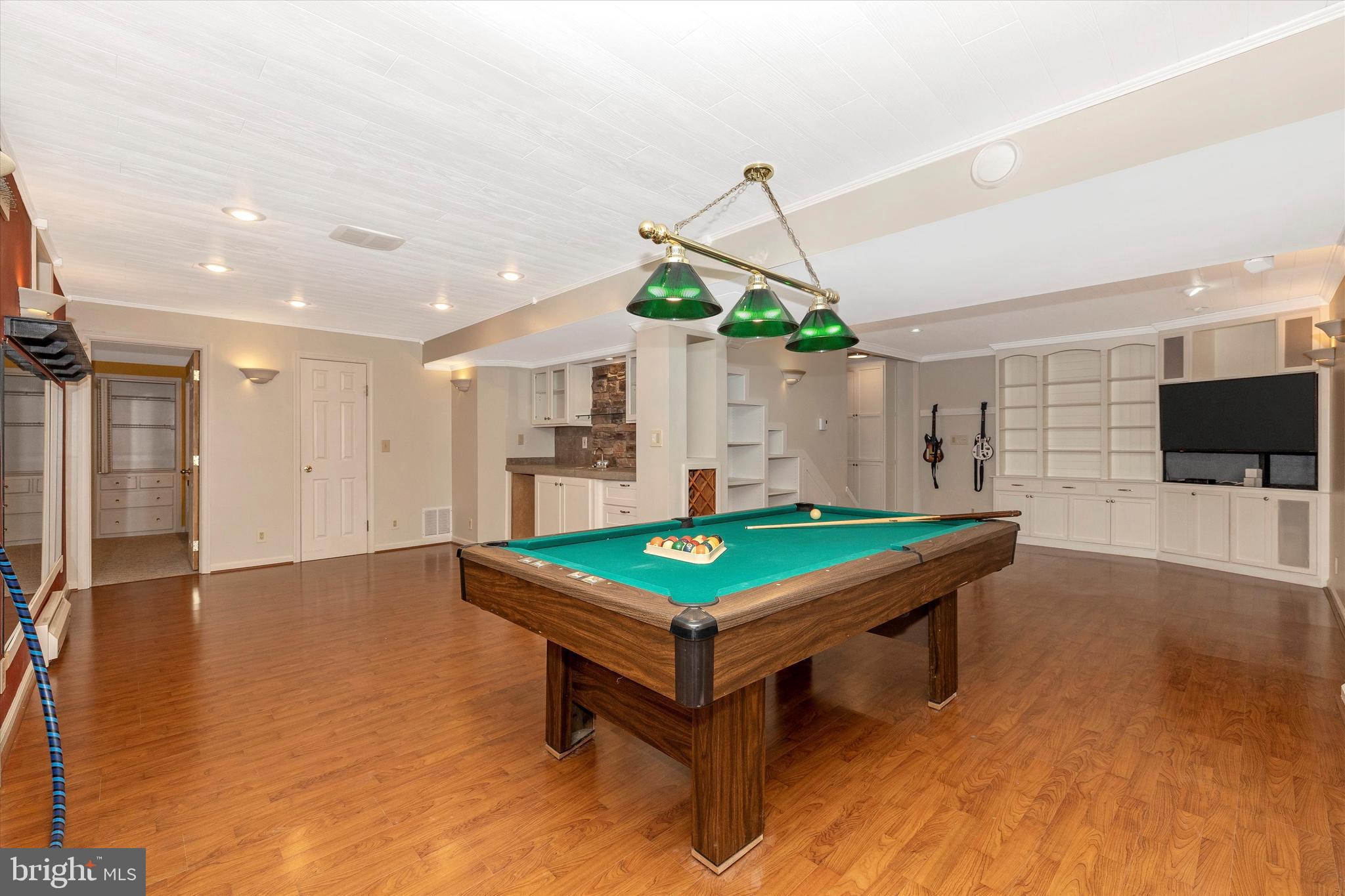 18840 Falling Star Road Germantown, MD 20874 - Photo 37 of 68 pool table conveys, built in cabinets with TV