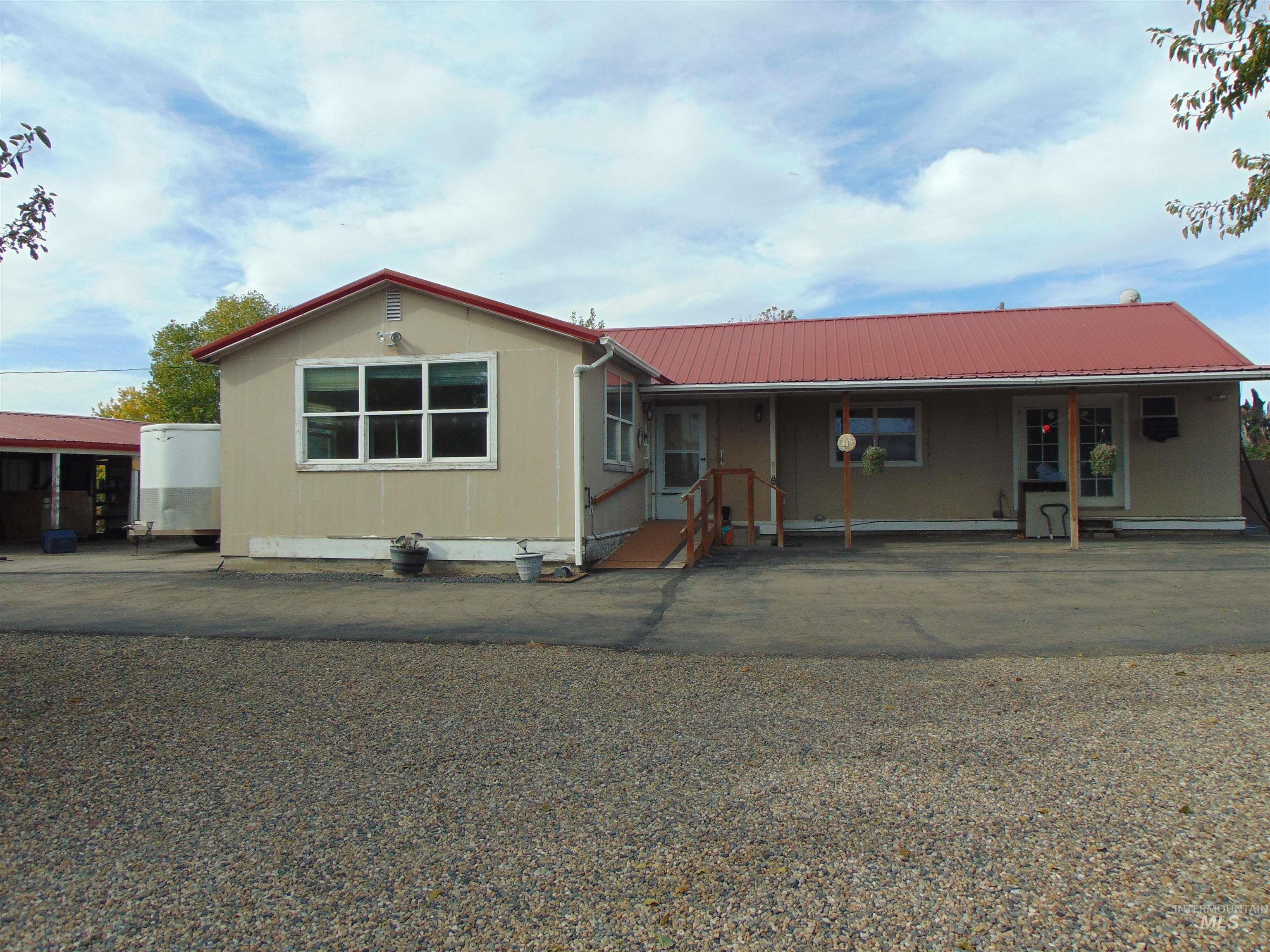 View of front of house featuring a metal roof and a porch