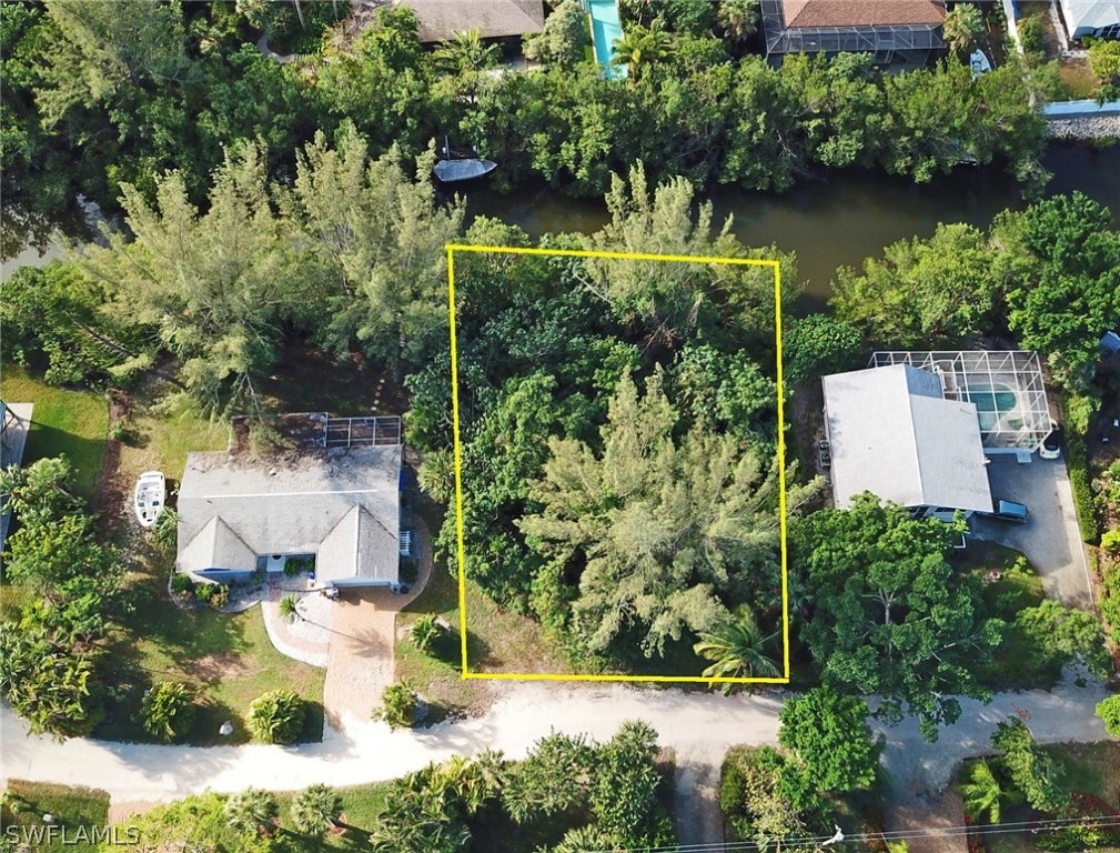 5847 Pine Tree Drive Sanibel, FL 33957 - Photo 7 of 20 an aerial view of a house with yard and lake view